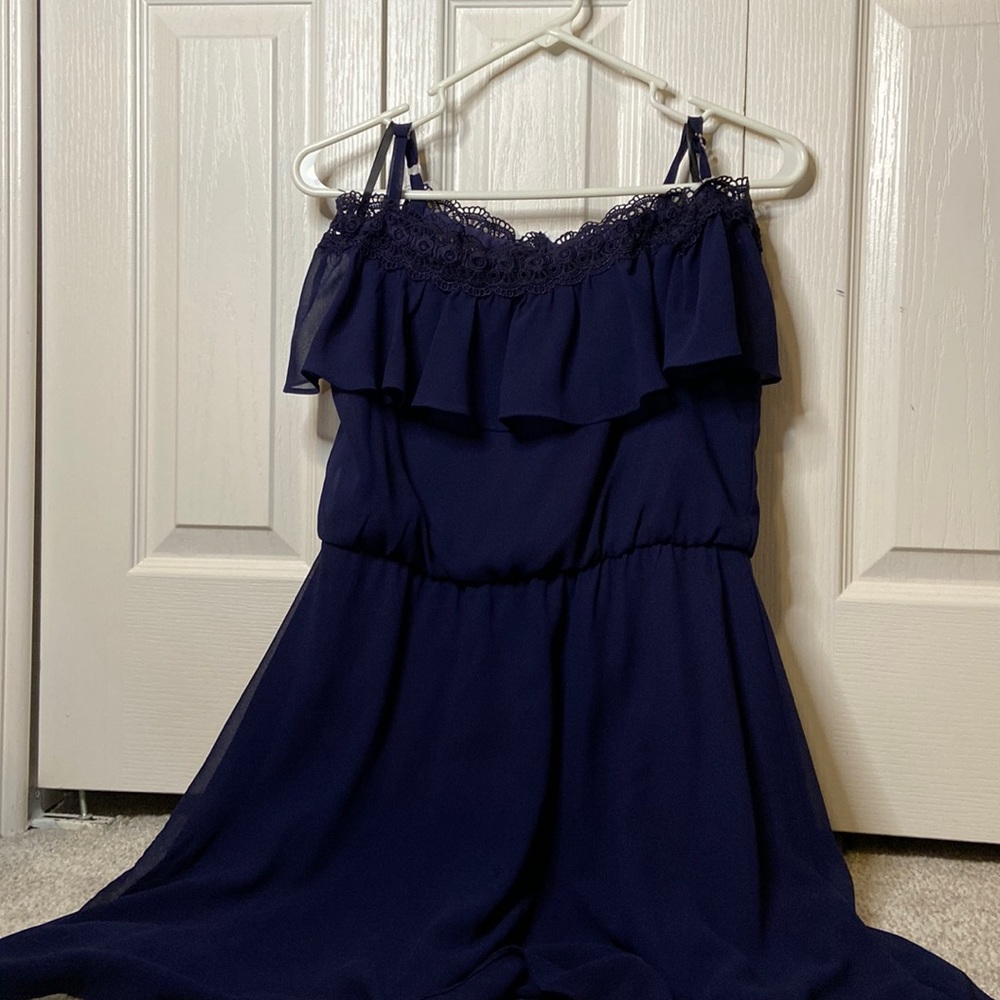 Girls navy dress with lace trio on top.